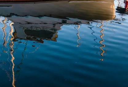 Boat and its reflection on Lake Ontario