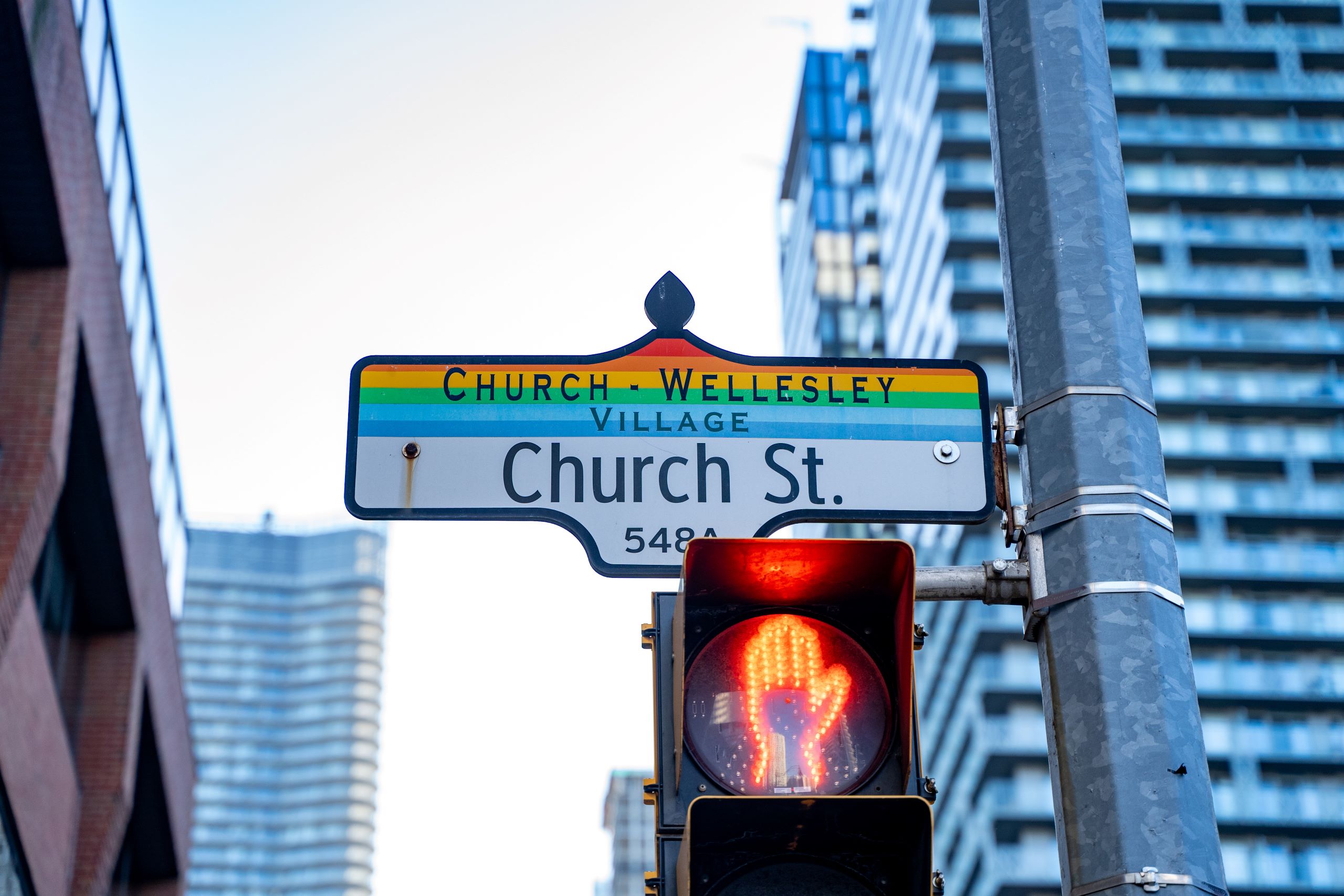 A street sign for Church Street with the rainbow color scheme indicating a street in the Church and Wellesley gay village in Toronto.