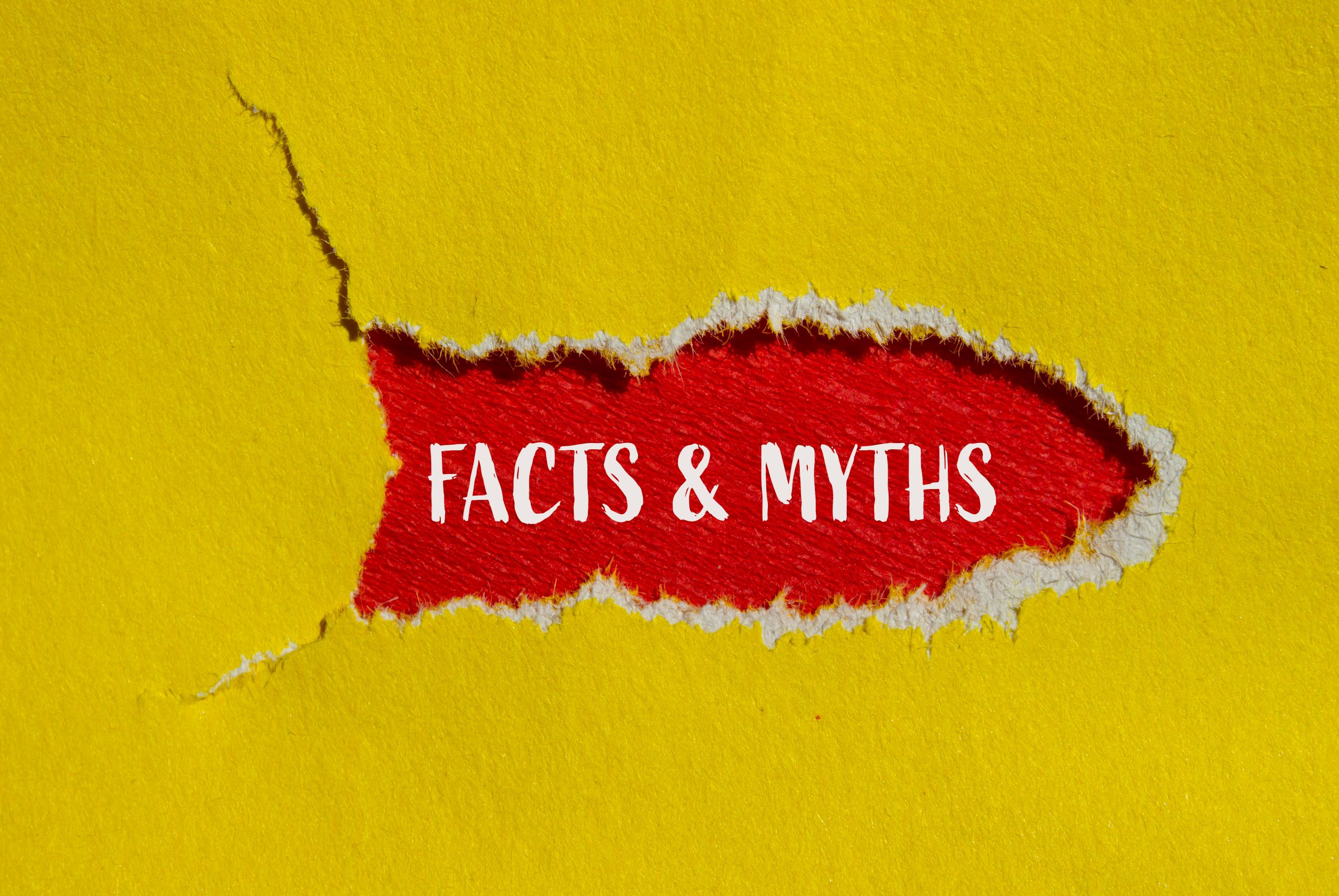 Facts and myths words written on ripped yellow paper with red background. Conceptual facts and myths symbol.