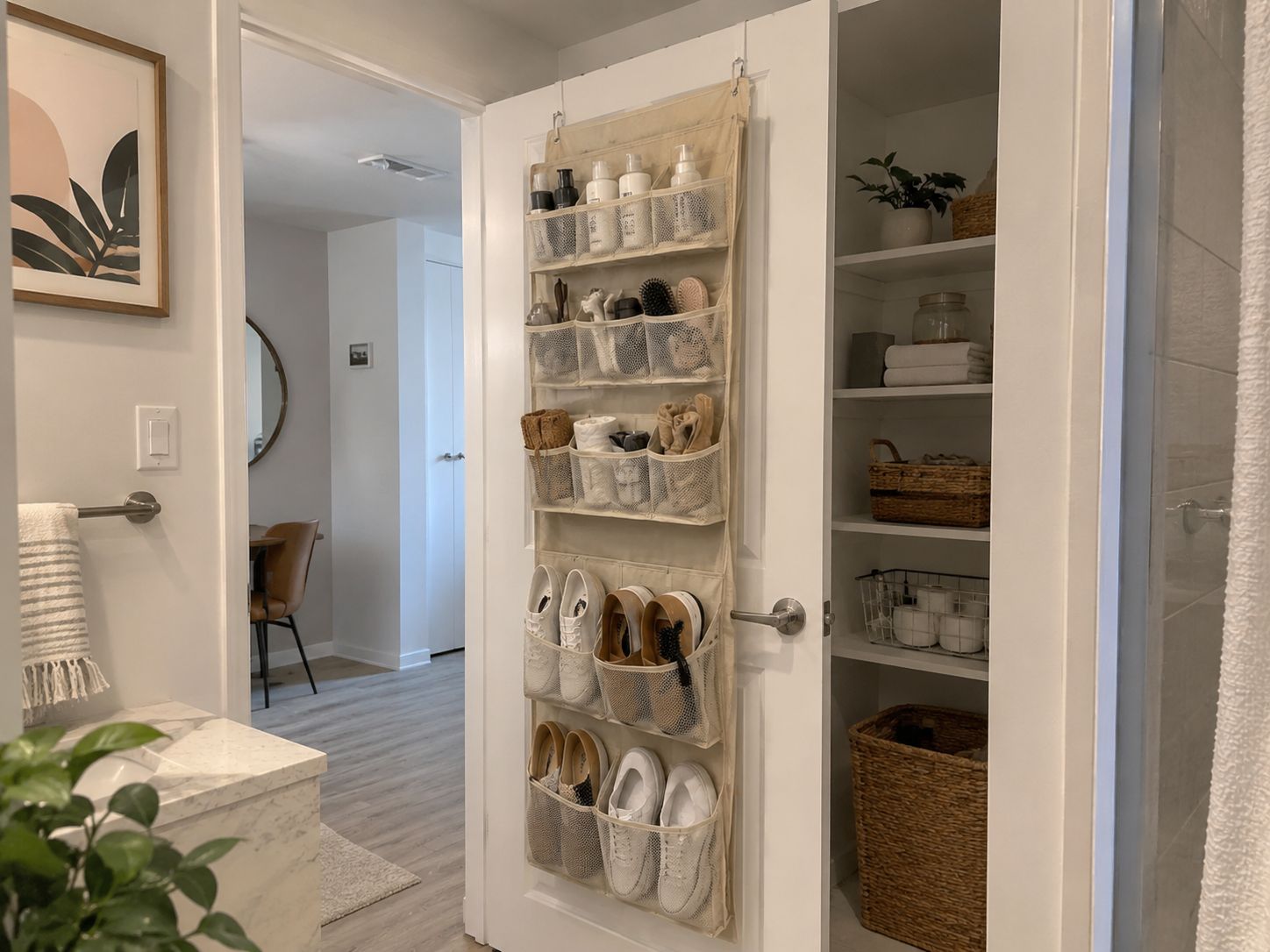 Bathroom door with an over-the-door organizer holding shoes, toiletries, towels, and small items.