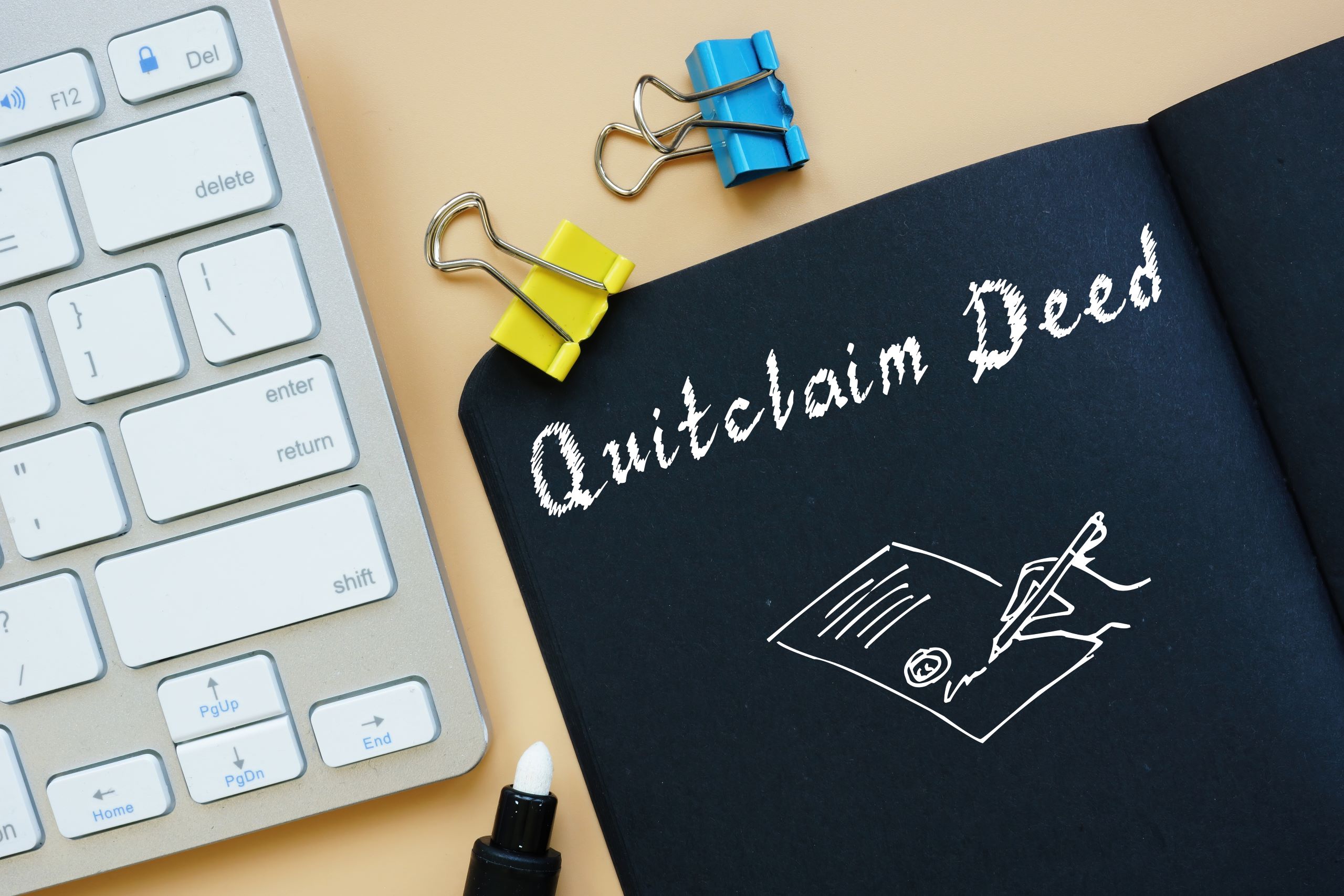 Quitclaim Deed sign on the piece of paper.